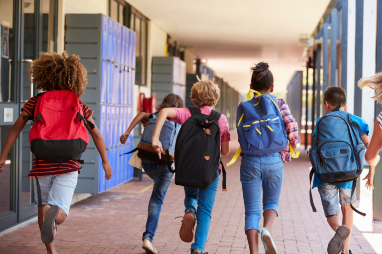 Students walking through a school corridor during the school day